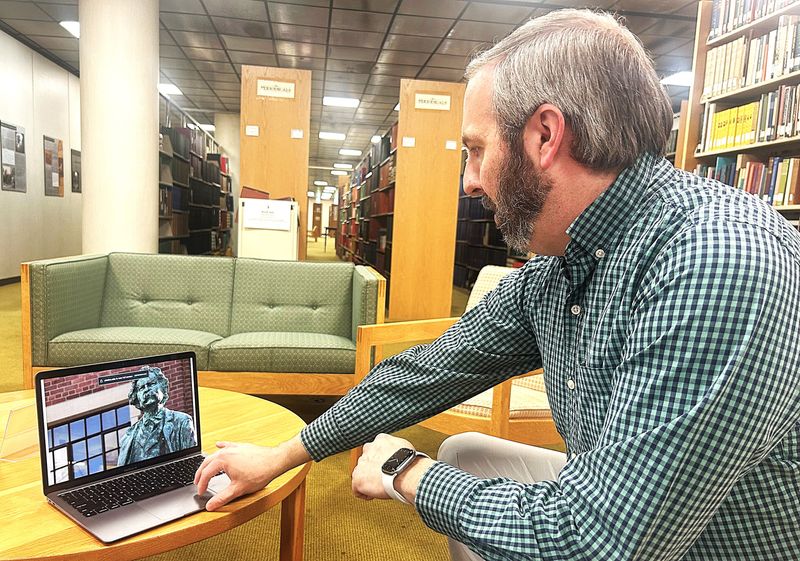Justin Cates, digital content producer for Elmira College, demonstrates how to use the new virtual Mark Twain Trail that allows visitors to explore key locations around Elmira connected to the famous author's life and works.