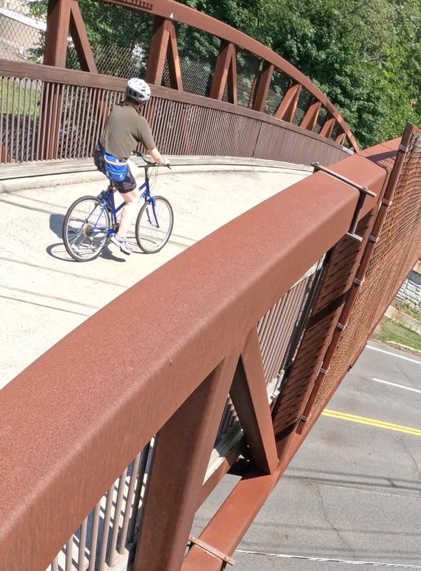 A bicyclist rides on the Joseph B. Clarke Rail Trail  where a bridge carries the trail over Rt. 303 in Orangeburg July 22, 2026.
