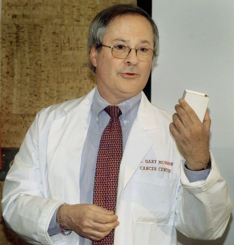 Gary Morrow, Ph.D., holds up an ambulatory monitor, which was developed in Amsterdam, that will help manage and control the side effects of chemotherapy such as nausea on Feb. 2, 2001, at the Wilmot Cancer Center at the University of Rochester.