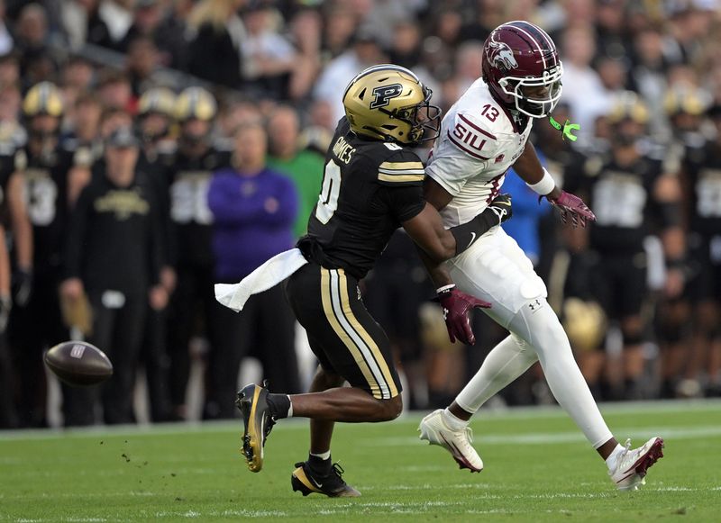 Sep 6, 2025; West Lafayette, Indiana, USA; Southern Illinois Salukis wide receiver Jay Jones (13) misses a pass under coverage from Purdue Boilermakers defensive back Tony Grimes (0) during the first quarter at Ross-Ade Stadium. Mandatory Credit: Marc Lebryk-Imagn Images