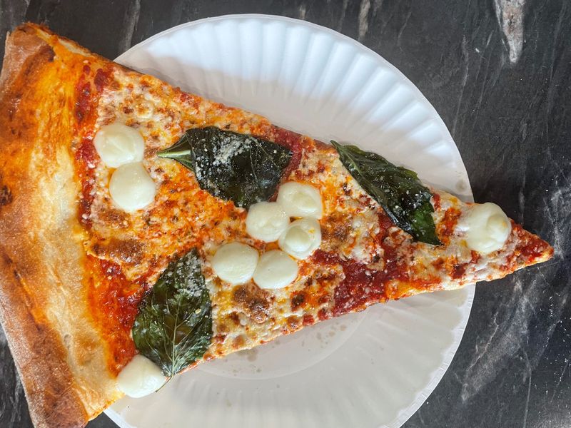 Margherita slice at Trio Pizza in Baldwin Place, photographed July 2026.