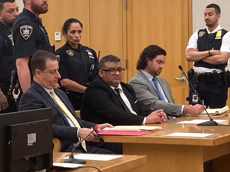 John Singh, sitting between his lawyers Richard Ferrante, left, and Daniel Harnick, in Westchester County Court July 29, 2026, as he was sentenced to the maximum, 25-years to life in prison, for the murder of his brother-in-law Bernard Barua on Nov. 16, 2024, in the victim's Yonkers apartment.