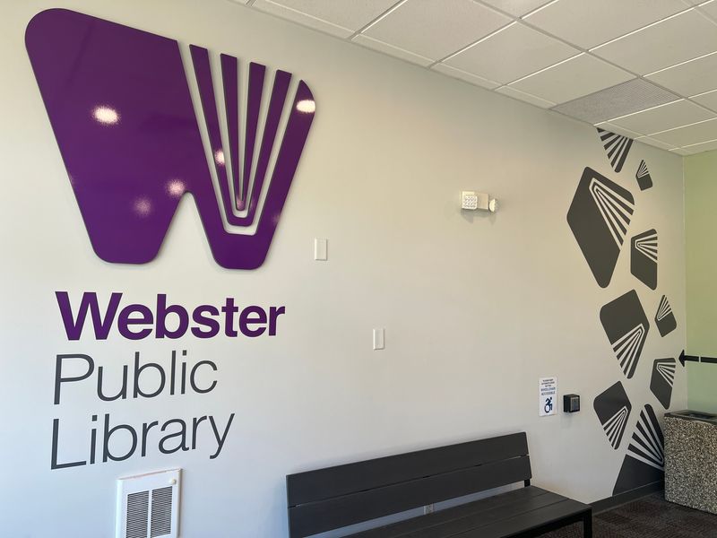 The entryway to Webster Public Library, which is located in the Webster Plaza, on July 31, 2026. The Town of Webster is reviewing the possibility of constructing a new library building.