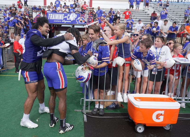Ty Johnson tells the crowd that it is Max Hairston’s birthday today as Hairston signs autographs after practice at Buffalo Bills Training Camp at St. John Fisher University in Pittsford on Aug. 6, 2026.  Some in the crowd sang happy birthday to him.