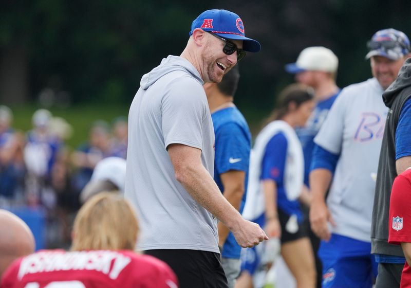 Bills head coach Joe Brady laughs with players at the end of day six of Buffalo Bills training camp at St. John Fisher University Thursday, August 5, 2026 in Pittsford.