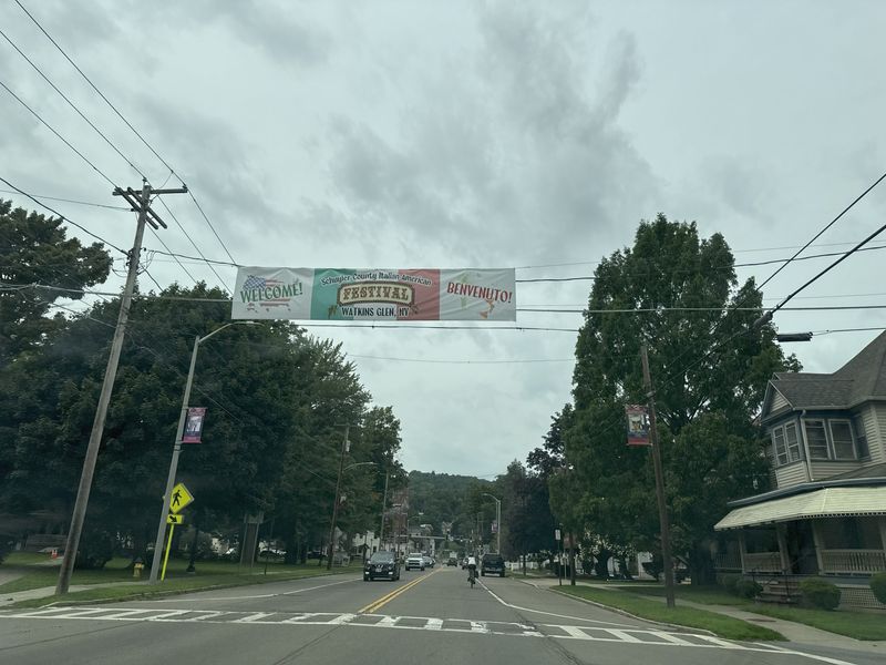 An overhead sign in downtown Watkins Glen highlights the 2026 Schuyler County Italian American Festival coming up Aug. 13-15.