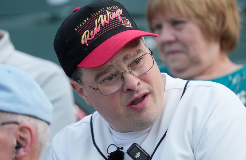 Red Wings super fan Chris Wells watches the action on the field from his families seats in Section 111, Row F, as he attends Rochester’s game against Charlotte at ESL Ballpark in Rochester Tuesday, August 11, 2026.  Wells was honored before the game, as it marked his 1,000th straight Red Wings game attending as a fan.