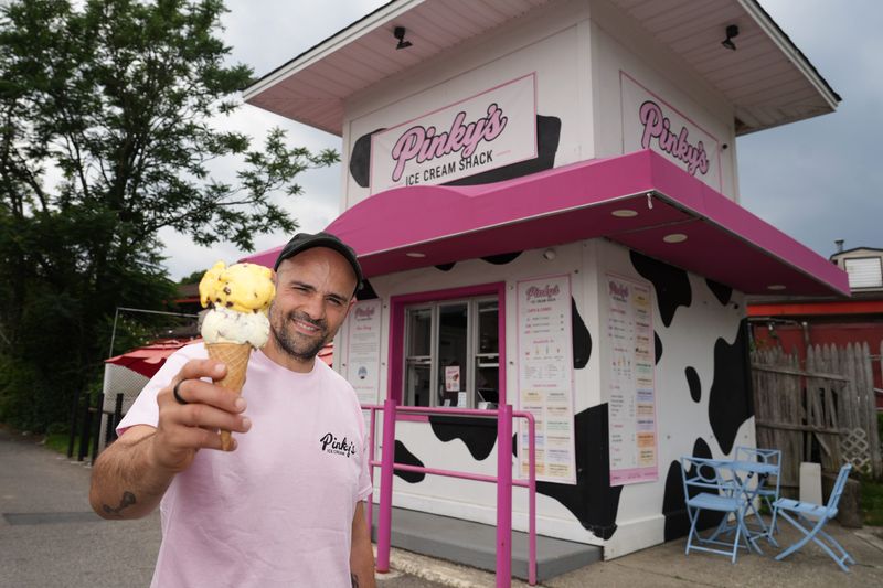 Chef and owner Matt Mancuso with a scoop of dark chocolate passion fruit and a scoop of sweet corn and blueberry ice cream cone at Pinky's Ice Cream Aug. 11, 2026 in Cortlandt Manor. The small-batch, house-made craft ice cream shop features hyper-local Hudson Valley Fresh dairy with rotating seasonal flavors.