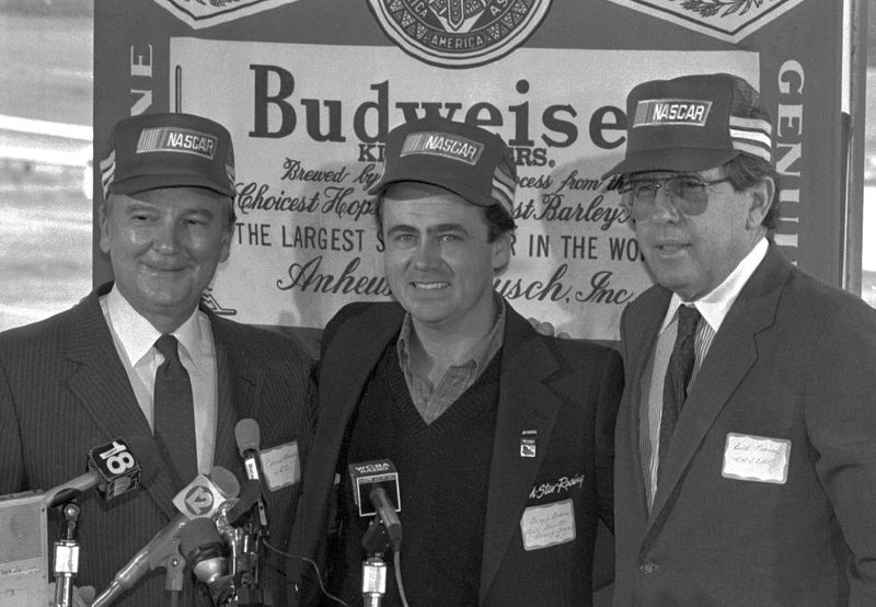 Watkins Glen International board chairman Conrad Stemski , NASCAR driver Geoff Bodine, and NASCAR President Bill France Jr., left to right, gather on Oct. 17, 1985 to tell the media that NASCAR would be returning to the racetrack in 1986.