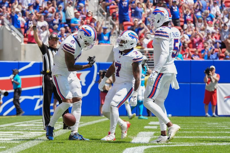 Aug 15, 2026; Orchard Park, New York, USA; Buffalo Bills wide receiver Keon Coleman (0) celebrates catching a touchdown with Buffalo Bills running back Ray Davis (7) and Buffalo Bills wide receiver Joshua Palmer (5) during the first half aginst the Carolina Panthers at New Highmark Stadium.