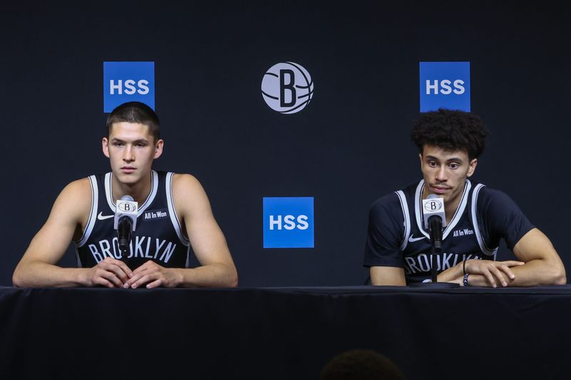 Sep 23, 2025; Brooklyn, NY, USA;  Brooklyn Nets guards Egor Demin (8) and Nolan Traore (88) speak at Media Day. Mandatory Credit: Wendell Cruz-Imagn Images