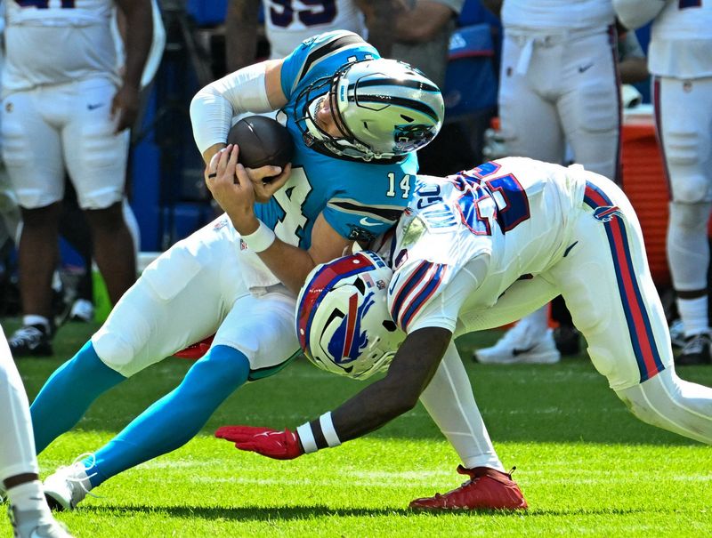 Aug 15, 2026; Orchard Park, New York, USA; Carolina Panthers quarterback Kyle Trask (14) is tackled by Buffalo Bills defensive back Jalon Kilgore (29) in the fourth quarter at the New Highmark Stadium.