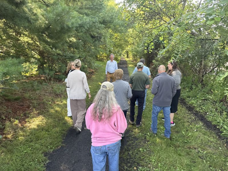 Officials tour the Catharine Valley Trail moments after the ribbon cutting event celebrating a $250,000 project that brings new signage, maps, multilingual stories and an interactive app to the trail. 