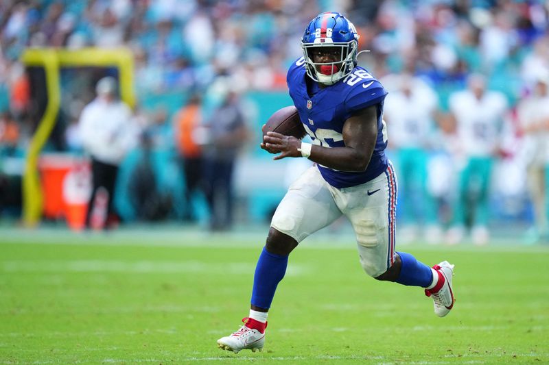 Aug 22, 2026; Miami Gardens, Florida, USA;  New York Giants running back Devin Singletary (26) runs the ball in for a touchdown against the Miami Dolphins during the second quarter of a preseason game at Hard Rock Stadium.  Mandatory Credit: Rich Storry-Imagn Images