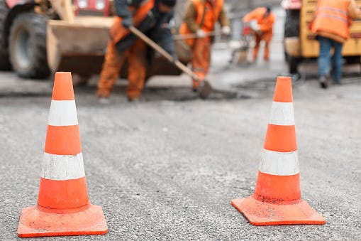 Road workers repair a road.