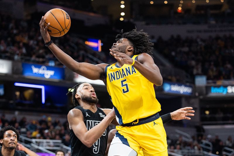 FILE PHOTO: Mar 20, 2025; Indianapolis, Indiana, USA; Indiana Pacers forward Jarace Walker (5) shoots the ball while Brooklyn Nets forward Trendon Watford (9) defends in the first half at Gainbridge Fieldhouse. Mandatory Credit: Trevor Ruszkowski-Imagn Images