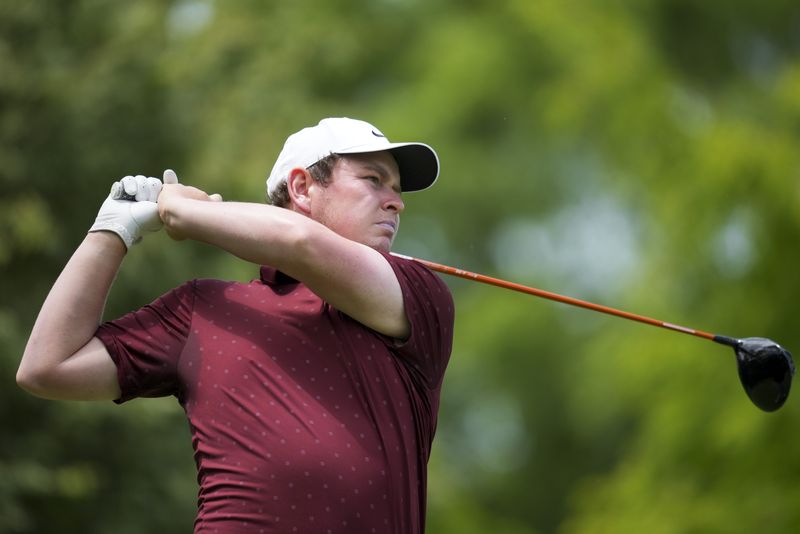 FILE PHOTO: May 29, 2025; Dublin, Ohio, USA; Robert MacIntyre plays his shot from the second tee during the first round of the Memorial Tournament presented by Workday golf tournament. Mandatory Credit: Aaron Doster-Imagn Images/File Photo
