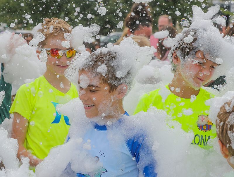 Children enjoy the bubble machine at the Fun in the Sun event hosted by Northeast Ohio Parent Magazine  on Thursday, Aug. 11, 2022 in Hudson, Ohio, at First & Main.