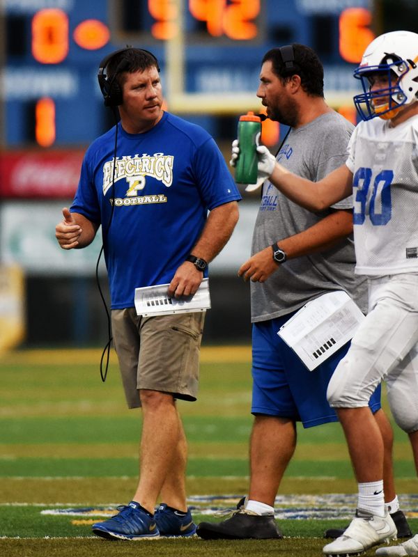 Philo coach Dirk Lincicome and assistant coach Josh Wright talk during a timeout. The Electrics topped visiting Meadowbrook, 23-6, in their OHSAA Jamboree game on June 17, 2017, at Sam Hatfield Stadium.