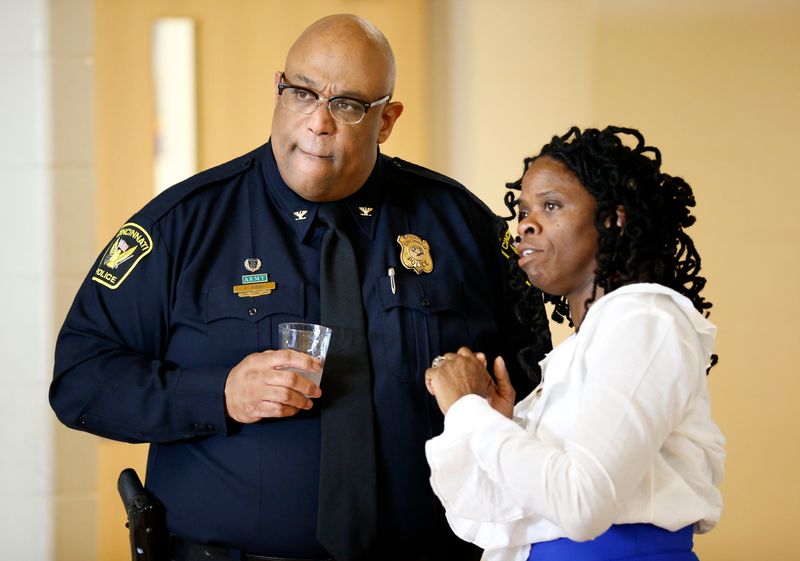 Cincinnati Police Chief Eliot Isaac talks with community activist Iris Roley before a community meeting to discuss the future of the city's Collaborative Agreement at Taft High School in the West End neighborhood of Cincinnati on Tuesday, Sept. 26, 2017.