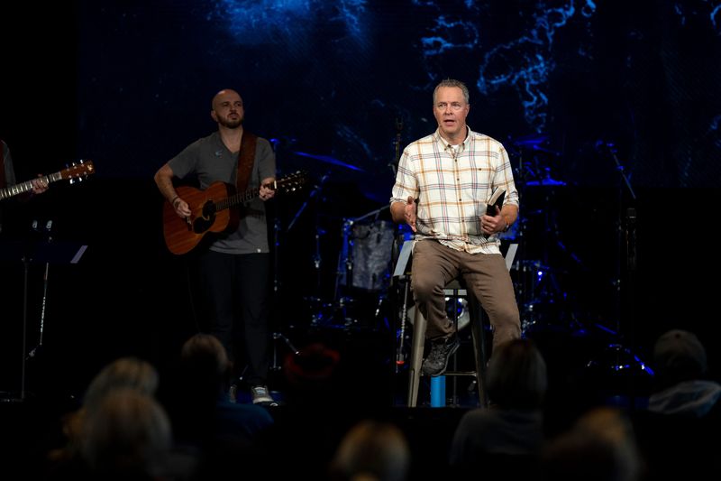Brian Tome, pastor at Crossroads Church, leads a prayer service in 2023.