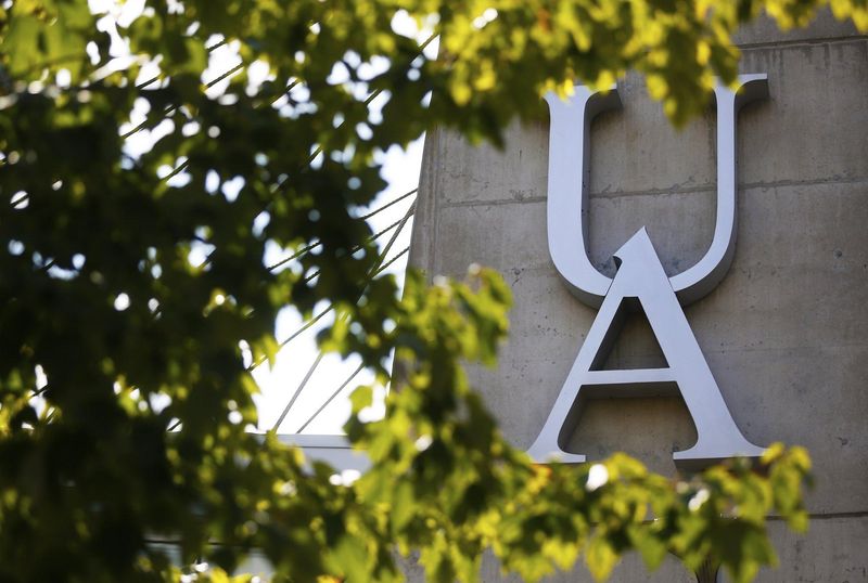 The University of Akron logo seen through the trees on Buchtel Avenue, Wednesday, Aug. 21, 2019.