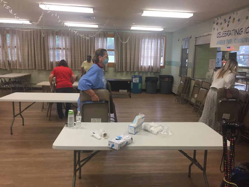 Volunteers work Friday to get the Warren Township Community Center in New Cumberland ready for its reopening on Monday.