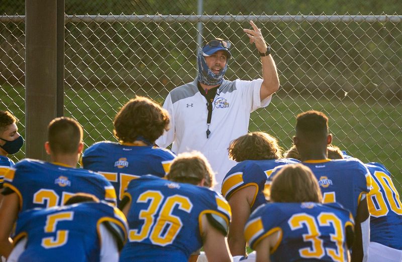 Mark Solis, shown here addressing his Olentangy team before a 2020 game against Olentangy Berlin, has been named the next football coach at New Albany.