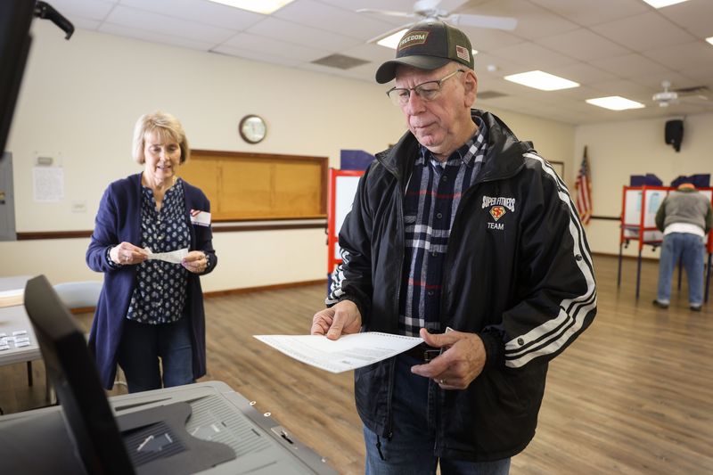 Voter Larry Gehrett submits his ballot on Election Day, Tuesday, May 2, 2023 at the Randolph Community Center in Randolph, OH.