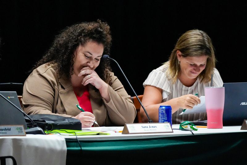 Sara Jonas, a board member of Forest Hills Board of Education, laughs quietly on Wednesday, June 28, 2023, during the Forest Hills Board of Education meeting at Mercer Elementary School in Cincinnati.