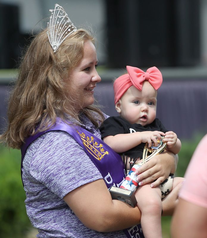 2023 Columbiana County Dairy Princess Kaitlyn Bondoni of Alliance holds baby contest winner in the 6-month to 12-month girls category, Karsyn Donato, 8 months, at the 2023 Knox Township Festival in July 2023 at North Georgetown Fire Station.
