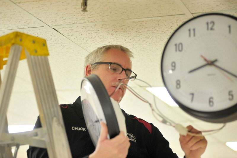 Chuck Minich, superintendent of maintenance for Richland County commissioners, takes a look inside one of the courthouse clocks that will be advanced one hour when daylight saving time begins.