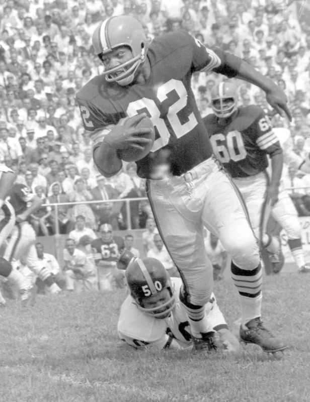 Cleveland Browns fullback Jim Brown is shown breaking a tackle during the 1963 Pro Football Hall of Fame Game at Fawcett Stadium in Canton. Brown carried the ball 291 times for 1,863 yards in 14 games during the 1963 season.