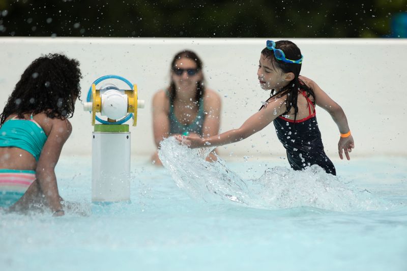 Samantha Smilek, 8, of Madeira, plays with another child at the Dunham Recreation Center Complex in West Price Hill on June 8, 2020. The Dunham pool opened for the 2026 season May 30.