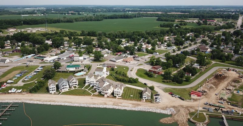 An aerial photo shows work continuing on the Buckeye Lake dam replacement, a $110-million project that began in 2015 at the popular resort area 25 miles east of Columbus and was completed in 2018. Plans call for the new dam top to be clad in a concrete cap and topped with both grass and a paved path. The path will provide access for dam-safety inspectors and recreation for walkers, joggers and bicyclists. There are 371 homeowners along the 4.1-mile dam. The new dam replaces the nearly 200-year-old earthen dam that the U.S. Army Corps of Engineers said was at significant risk of failure. (Columbus Dispatch photo by Doral Chenoweth III)