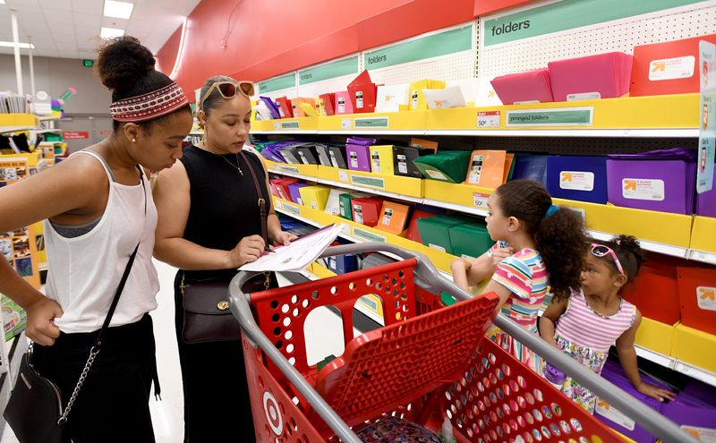 Chimere Hodoh, of Green, shops for school supplies with her kids at Target in Belden Village during Ohio's annual sales tax holiday.