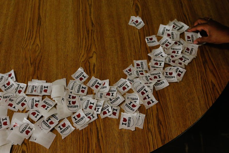 A voter takes an "I Voted" sticker after casting their ballot during Election Day on Tuesday, Nov. 3, 2020 at the Linden Community Center in Columbus, Ohio.