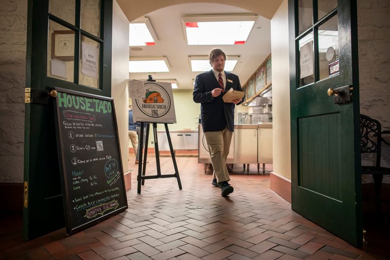 An Ohio Senate page leaves the Capitol Café with his lunch order from House Taco, which operated in the Statehouse space from 2021 to 2023. L.A. Catering, a division of LifeCare Alliance, will take over the cafe in mid-August.