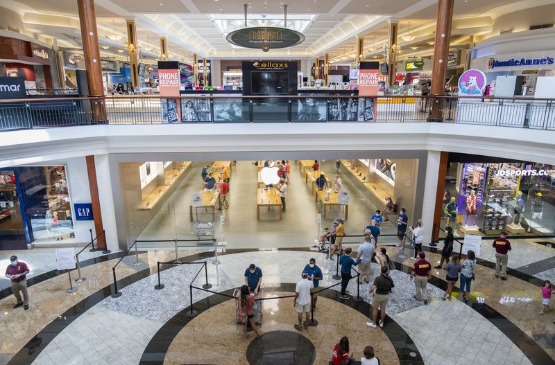Customers line up outside the Apple Store at Polaris Fashion Place on Friday, June 26, 2020.
