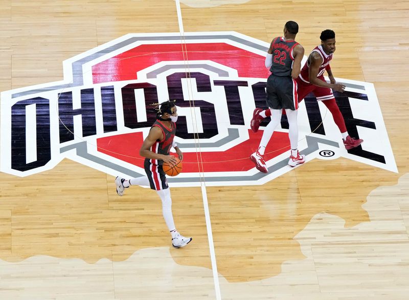 Ohio State Buckeyes guard Meechie Johnson Jr. (0) crosses center court as teammate Ohio State Buckeyes guard Malaki Branham (22) guards Indiana Hoosiers guard Xavier Johnson (0) during the first half of Monday's NCAA Division I basketball game at Value City Arena in Columbus, Oh., on February 21, 2022.