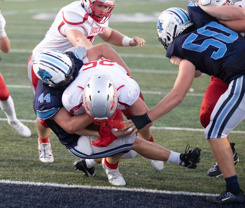 Northwest's Connor Satterfield bulls through Louisville defender Jacob Galbraith for a first half touchdown at Louisville Friday, August 1, 2023.
