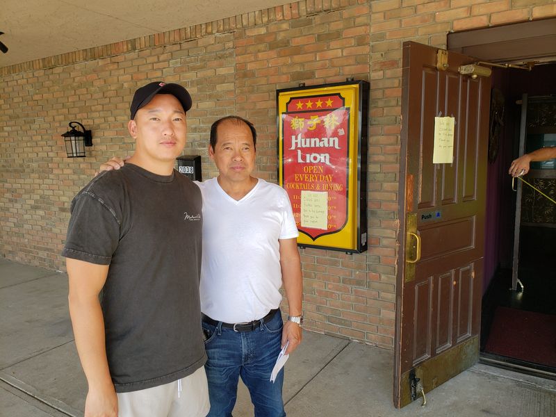 Steven Chang and his father, Jason Chang, greeted customers at the family's restaurant, Hunan Lion, in October 2023 after a fire shut down the business.