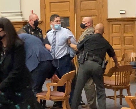 Jason McDermitt looks back to his parents, seated behind him in the Stark County Common Pleas courtroom, after jurors found him guilty of murdering Morgan Fox in April 2021.