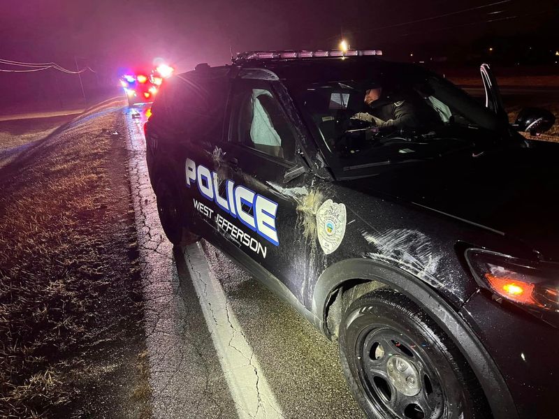 A West Jefferson police office was treated and released for injuries suffered in a wrong-way crash after a motorist entered the wrong lane of U.S. 40 and struck his cruiser.