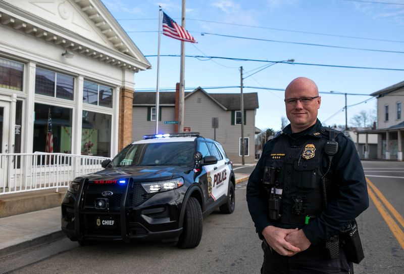 Pleasantville police Chief Nick Garver stands next to one of the village's police cruisers on Feb. 14, 2024.