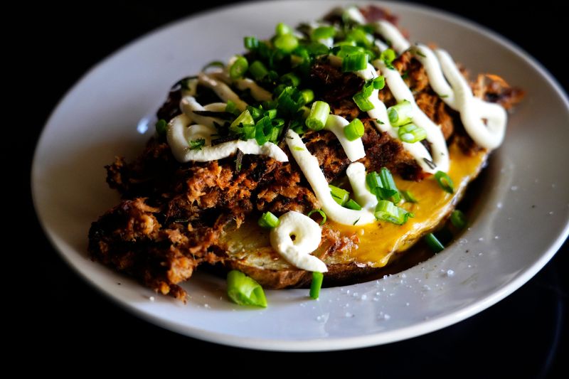 A loaded baked potato with smoked pork from the former Home Court Tavern, on Riverside Drive.