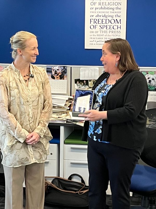 Leanne Graham, former president and CEO of Summit County's Victim Assistance Program, presents Beacon Journal reporter Stephanie Warsmith with the Rev. Dr. Robert A. Denton Outstanding Victim Services Award.