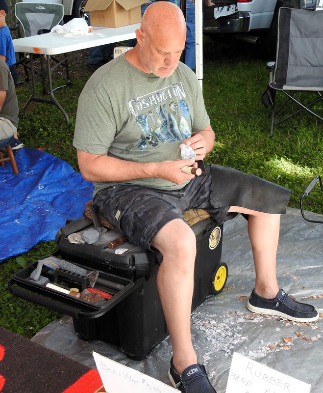 Kevin Gwinner of Willard works on a piece of flint to create an arrowhead at a previous Coshocton Flint Festival and Knap-In. This year's event is May 22-24, at the Coshocton County Fairgrounds.