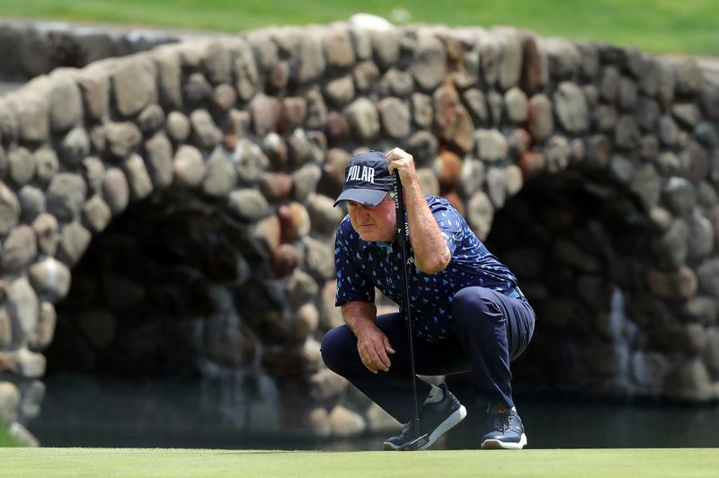 Gene Sauers reads the green on the third hole during the first round of the Kaulig Companies Championship at Firestone Country Club, Thursday, July 11, 2024, in Akron, Ohio.