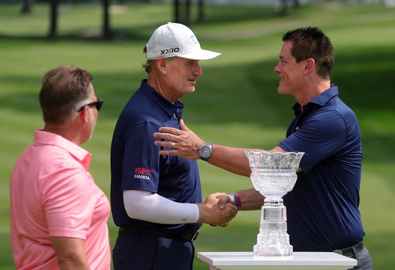 Ernie Els shakes hands with Matt Kaulig during the trophy ceremony for the Kaulig Companies Championship golf tournament at Firestone Country Club, Sunday, July 14, 2024, in Akron, Ohio.